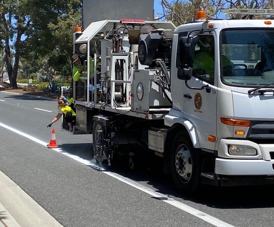 road workers setting out cones for roadwork